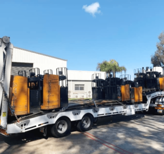 A truck loaded with pallet forklifts proving the service, machinery transport