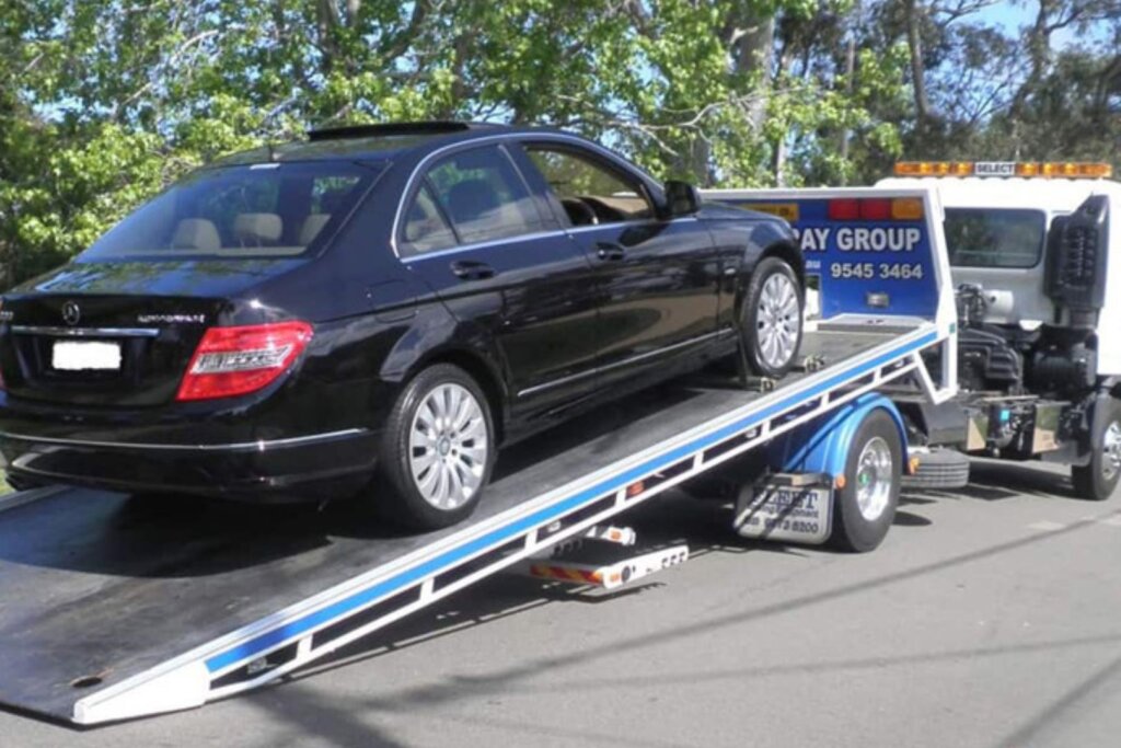 A car being loaded on a tow truck